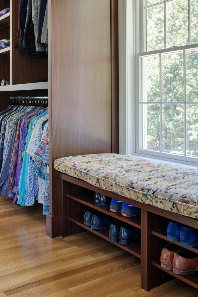 Photo of a transitional dressing room in Boston with dark wood cabinets.