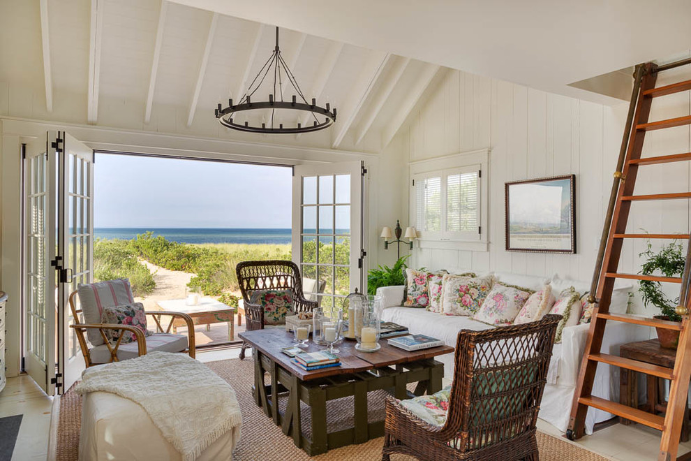 Design ideas for a mid-sized beach style enclosed family room in Boston with white walls.