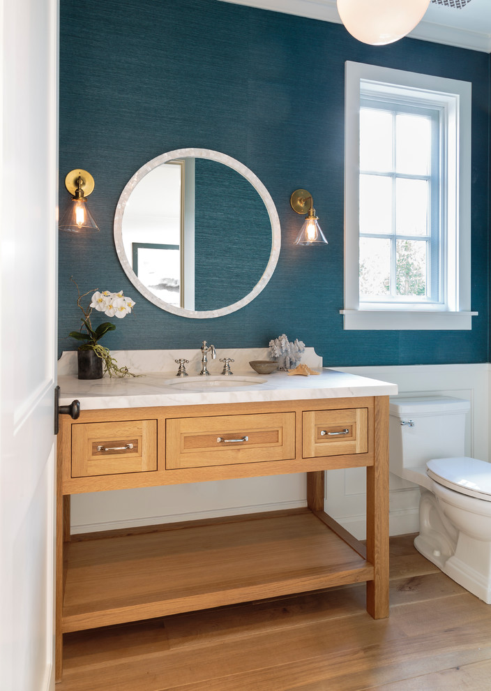 Design ideas for a beach style powder room in Los Angeles with blue walls.