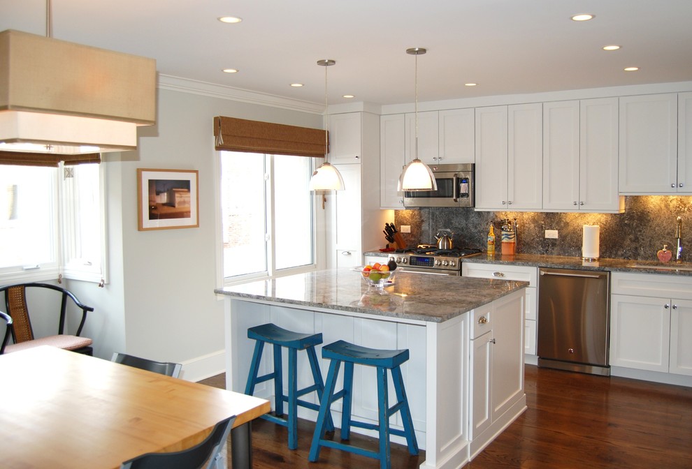 Transitional l-shaped eat-in kitchen photo in Chicago with an undermount sink, shaker cabinets, white cabinets, granite countertops, stone slab backsplash and stainless steel appliances