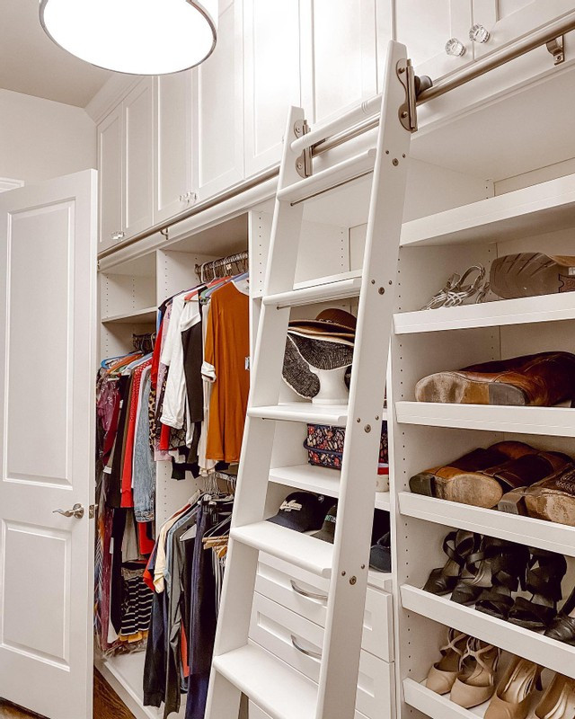This is an example of a contemporary gender neutral walk-in wardrobe in Los Angeles with shaker cabinets, white cabinets, laminate floors and brown floors.