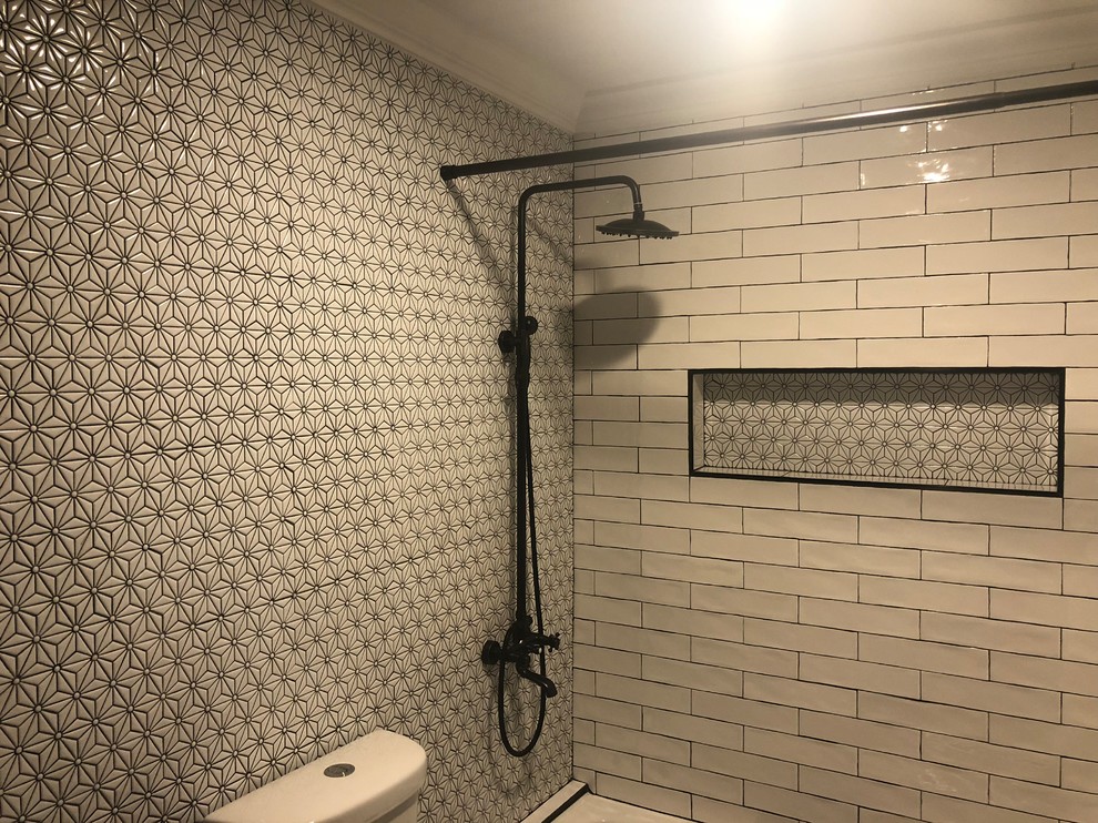 Inspiration for a mid-sized industrial 3/4 bathroom in Atlanta with a shower/bathtub combo, white walls and an integrated sink.