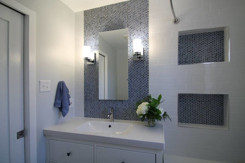 Small modern bathroom in Denver with flat-panel cabinets, white cabinets, an alcove tub, a shower/bathtub combo, a one-piece toilet, white tile, porcelain tile, blue walls, porcelain floors, an integrated sink and engineered quartz benchtops.