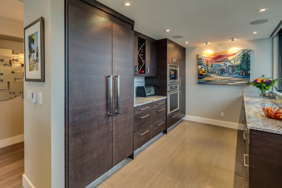 Photo of a mid-sized contemporary l-shaped open plan kitchen in Vancouver with an undermount sink, flat-panel cabinets, dark wood cabinets, quartz benchtops, white splashback, ceramic splashback, stainless steel appliances, ceramic floors and a peninsula.