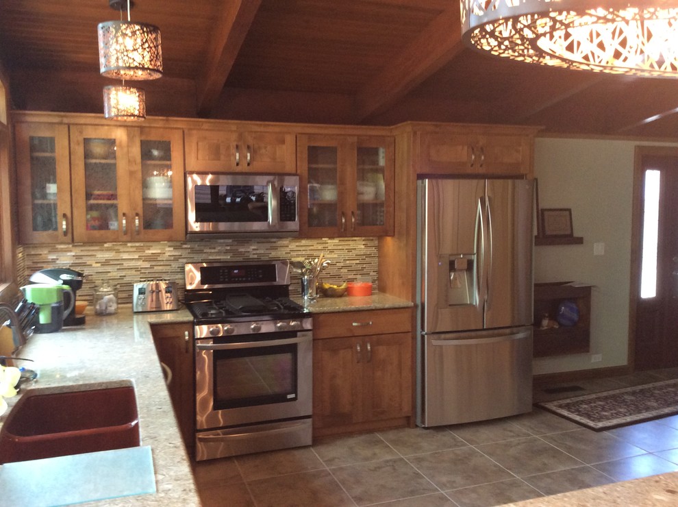 Inspiration for a rustic porcelain tile eat-in kitchen remodel in Chicago with shaker cabinets, medium tone wood cabinets, quartz countertops, multicolored backsplash, mosaic tile backsplash, stainless steel appliances, a peninsula and an undermount sink