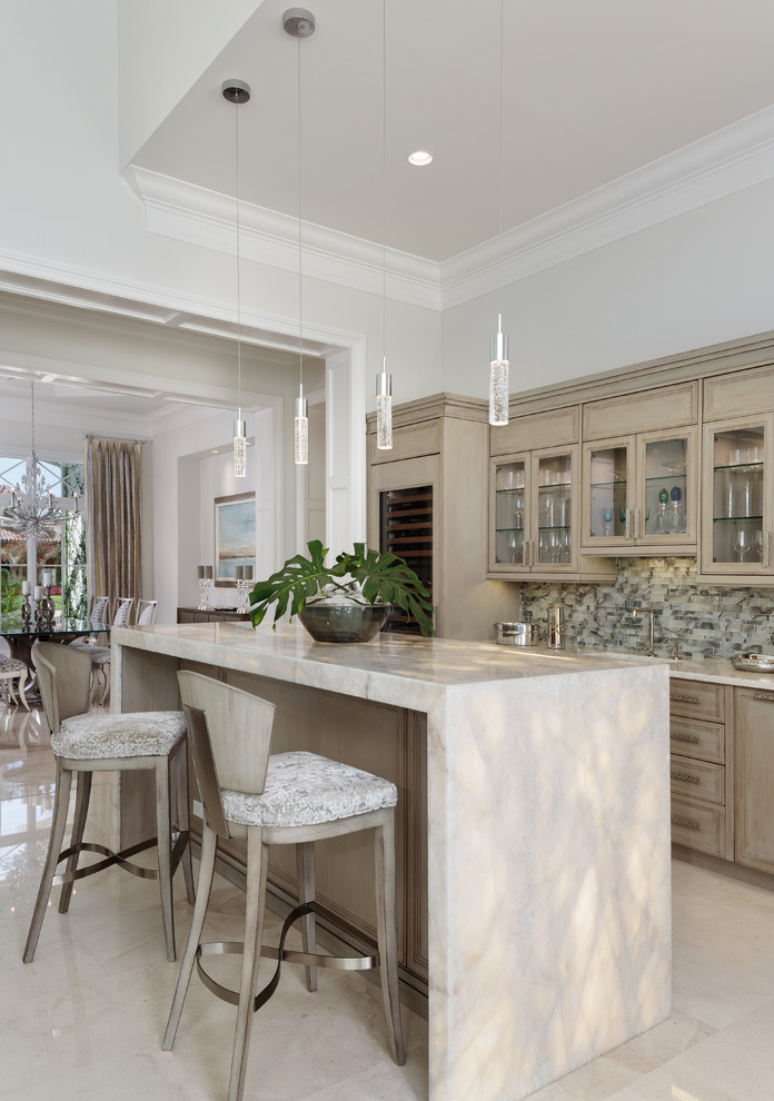 Photo of a mid-sized beach style galley seated home bar in Miami with shaker cabinets, light wood cabinets, granite benchtops, grey splashback, glass tile splashback, marble floors and white floor.