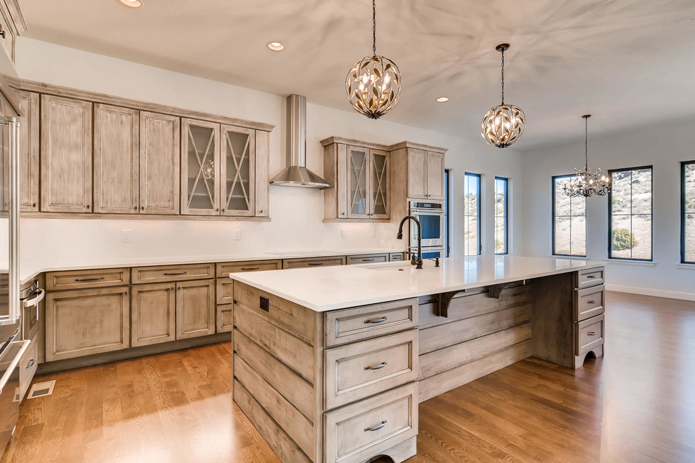 Large transitional l-shaped medium tone wood floor and brown floor open concept kitchen photo in Denver with flat-panel cabinets, medium tone wood cabinets, granite countertops, stainless steel appliances and an island