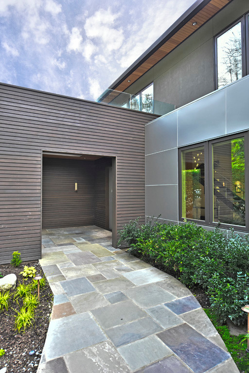Photo of a large contemporary three-storey grey exterior in Seattle with mixed siding and a hip roof.