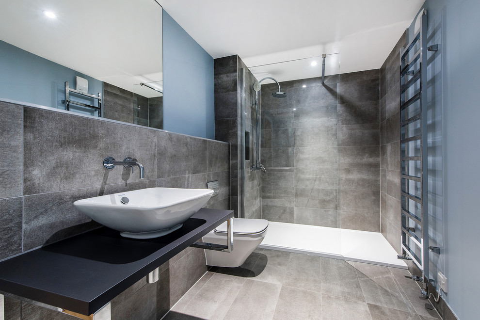 Inspiration for a contemporary 3/4 bathroom in Other with an alcove shower, a wall-mount toilet, stone tile, blue walls, a vessel sink and an open shower.