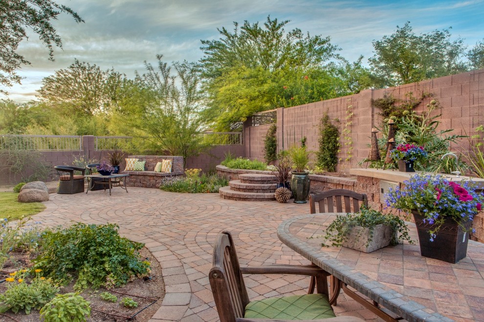 Design ideas for a large traditional backyard patio in Phoenix with a vegetable garden and brick pavers.