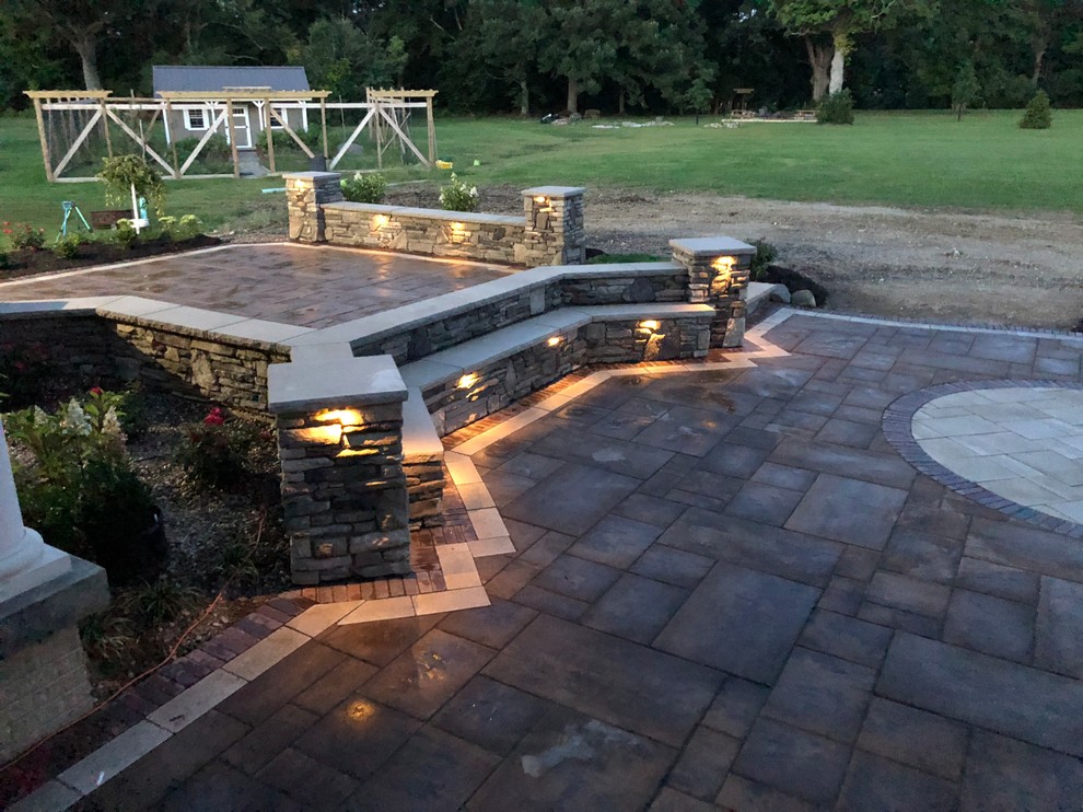 Inspiration for a large traditional backyard patio in Cleveland with a water feature, concrete pavers and no cover.