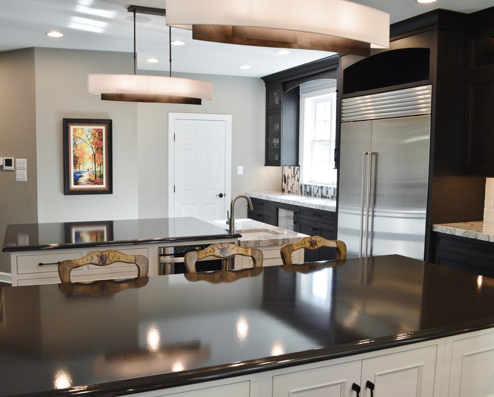Example of a large transitional l-shaped dark wood floor enclosed kitchen design in DC Metro with an undermount sink, dark wood cabinets, white backsplash, subway tile backsplash, stainless steel appliances, two islands and shaker cabinets