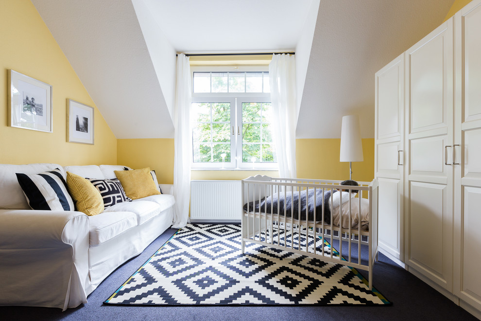Mid-sized transitional gender-neutral nursery in Hamburg with yellow walls, carpet and grey floor.