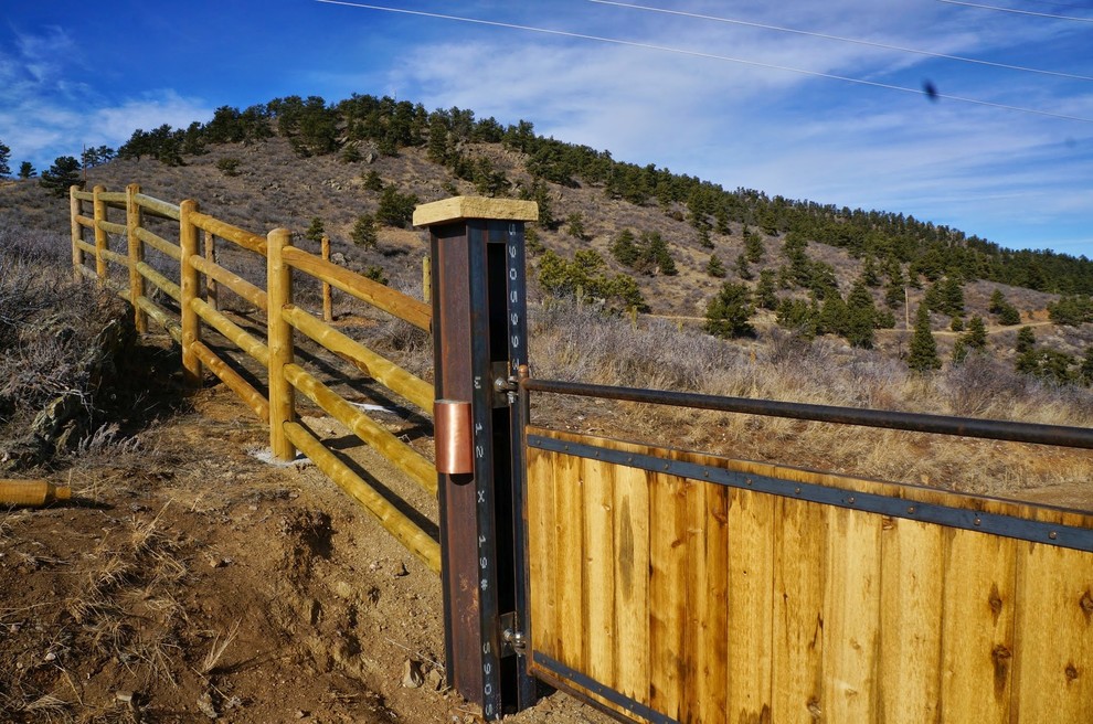 Photo of a large rustic full sun front yard driveway in Denver.