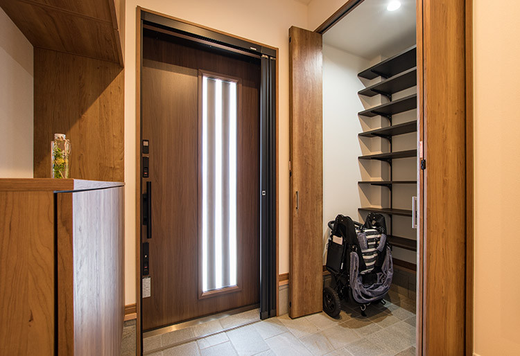 This is an example of a mid-sized modern entry hall in Other with white walls, a sliding front door, a dark wood front door, grey floor, wallpaper and wallpaper.