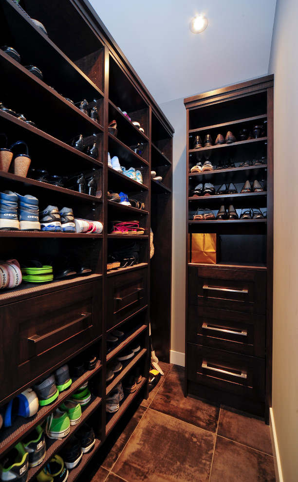 This is an example of a transitional walk-in wardrobe in Calgary with ceramic floors.