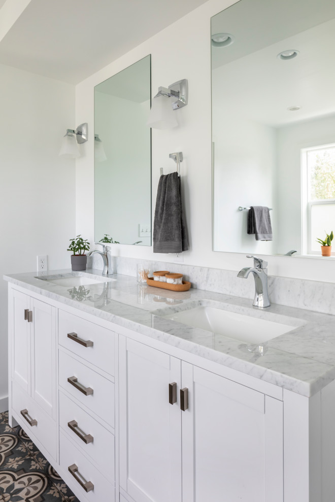 Photo of a mid-sized contemporary master bathroom in Seattle with beaded inset cabinets, white cabinets, white walls, porcelain floors, marble benchtops, blue floor, grey benchtops, a double vanity and a built-in vanity.