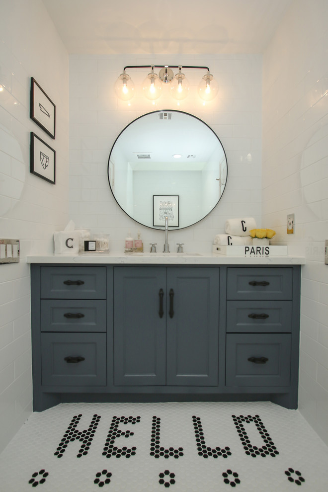 Design ideas for a small kids bathroom in Houston with shaker cabinets, blue cabinets, a freestanding tub, a one-piece toilet, white tile, subway tile, white walls, mosaic tile floors, an undermount sink, marble benchtops and white floor.