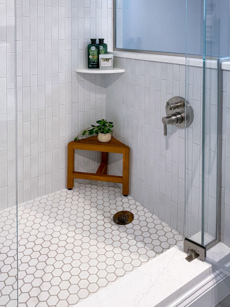 Inspiration for a transitional white tile and ceramic tile porcelain tile, gray floor and single-sink corner shower remodel in Boston with shaker cabinets, gray cabinets, a one-piece toilet, gray walls, an undermount sink, quartz countertops, a hinged shower door, white countertops and a built-in vanity