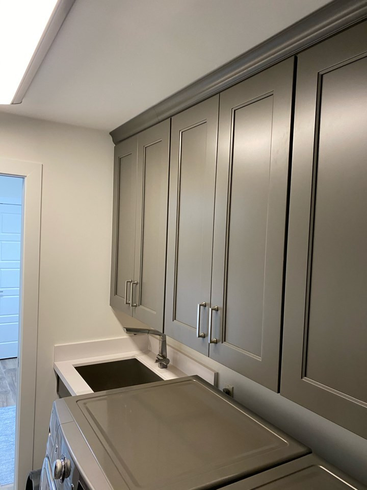 Inspiration for a traditional galley utility room in Phoenix with an undermount sink, recessed-panel cabinets, grey cabinets, quartz benchtops, white walls, porcelain floors, a side-by-side washer and dryer, white floor and white benchtop.