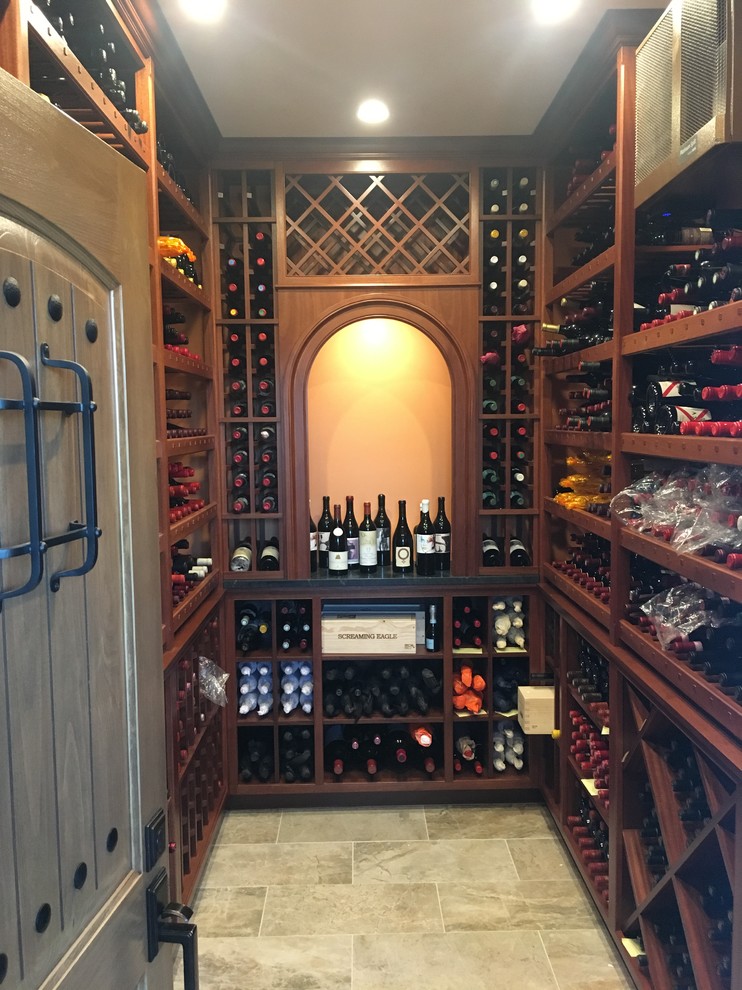 Photo of a large traditional wine cellar in Cincinnati with porcelain floors, storage racks and grey floor.