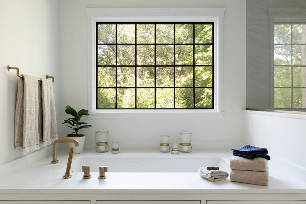 Inspiration for a large transitional master bathroom in Minneapolis with recessed-panel cabinets, white cabinets, an undermount tub, a curbless shower, a bidet, beige tile, porcelain tile, white walls, travertine floors, an undermount sink, engineered quartz benchtops, beige floor, an open shower and white benchtops.