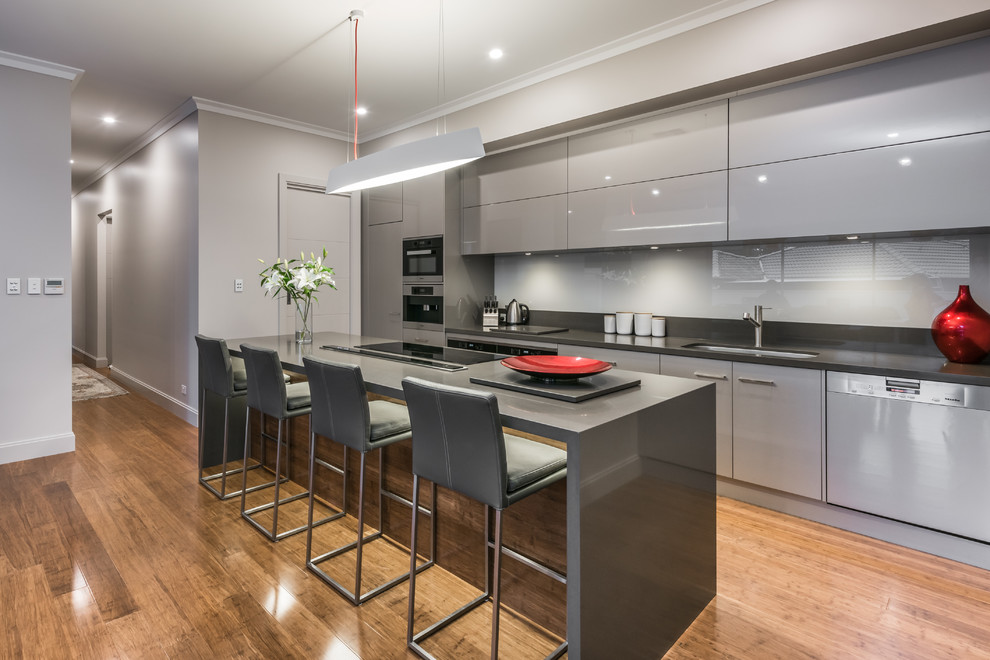 Design ideas for a contemporary galley kitchen in Adelaide with an undermount sink, flat-panel cabinets, grey cabinets, grey splashback and with island.