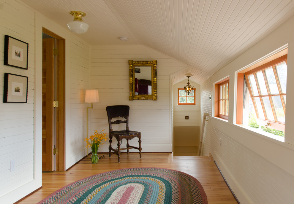 Photo of a beach style hallway in Portland with white walls and medium hardwood floors.