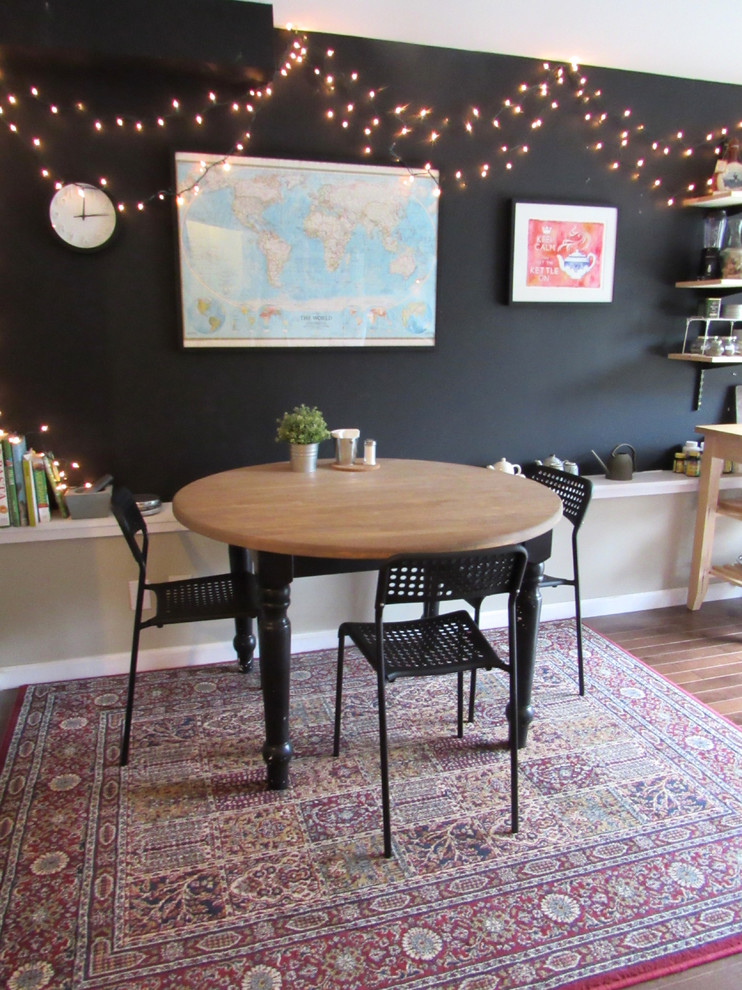 Example of a small eclectic dark wood floor kitchen/dining room combo design in San Francisco with black walls and no fireplace
