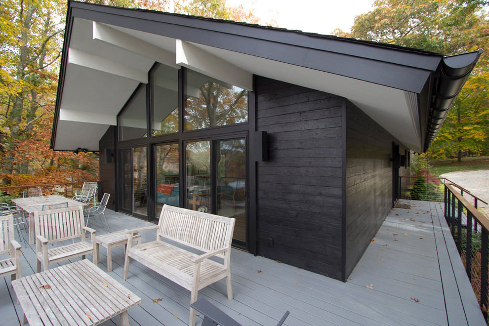 Photo of a modern black exterior in New York with wood siding.
