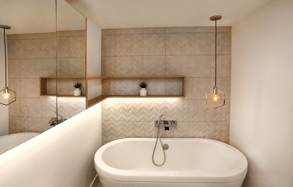 Inspiration for a small contemporary master bathroom in Vancouver with flat-panel cabinets, light wood cabinets, a freestanding tub, a one-piece toilet, beige tile, ceramic tile, beige walls, concrete floors, a vessel sink, engineered quartz benchtops and multi-coloured floor.