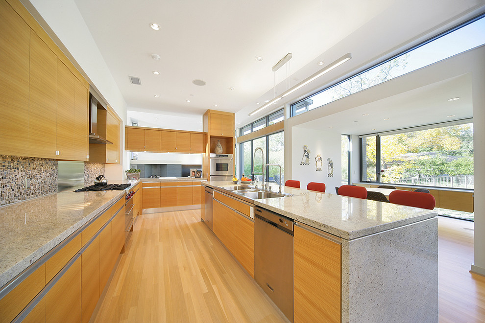 Photo of a contemporary kitchen in Dallas with mosaic tile splashback, stainless steel appliances, a triple-bowl sink, flat-panel cabinets, medium wood cabinets and multi-coloured splashback.