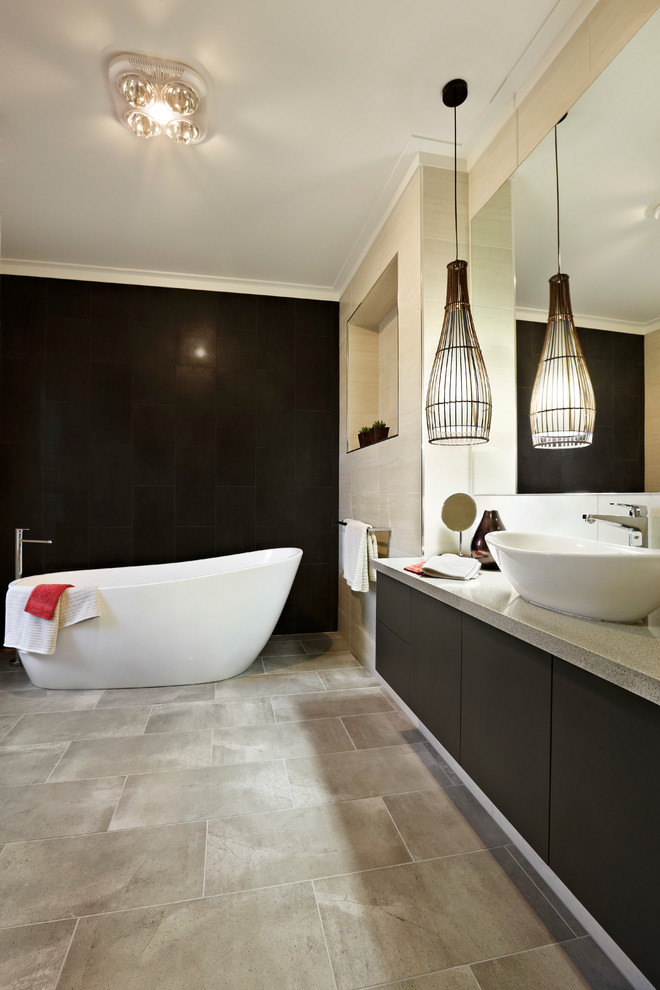 This is an example of a mid-sized contemporary master bathroom in Sydney with a vessel sink, flat-panel cabinets, engineered quartz benchtops, a freestanding tub, beige tile, ceramic tile, brown walls, ceramic floors and dark wood cabinets.