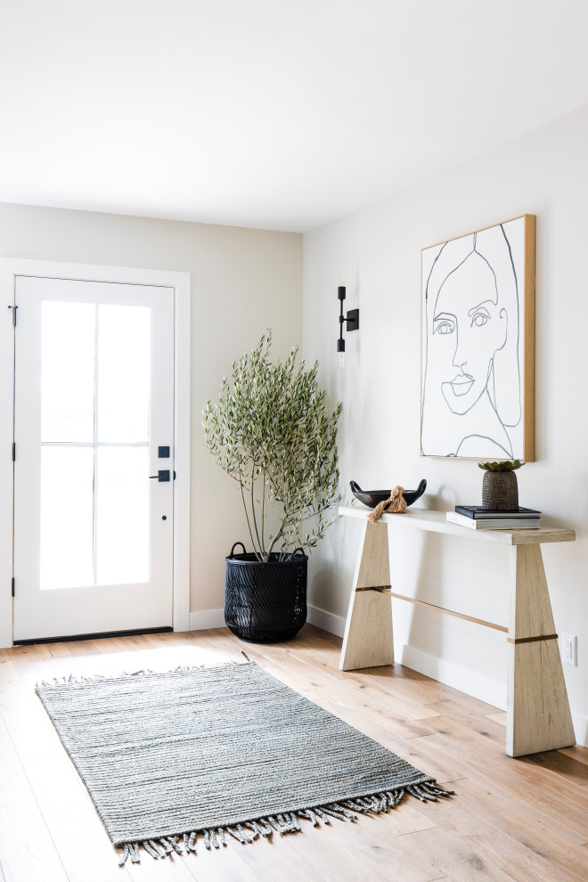 Foyer - transitional medium tone wood floor and brown floor foyer idea in Phoenix with beige walls and a glass front door