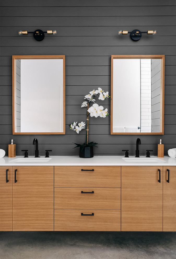 Design ideas for a retro ensuite bathroom in Austin with flat-panel cabinets, light wood cabinets, an alcove shower, grey walls, concrete flooring, a submerged sink, engineered stone worktops, an open shower, white worktops, double sinks, a floating vanity unit and panelled walls.