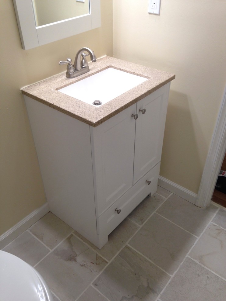 Inspiration for a small transitional 3/4 white tile and porcelain tile porcelain tile alcove bathtub remodel with an integrated sink, flat-panel cabinets, white cabinets, solid surface countertops, a one-piece toilet and beige walls