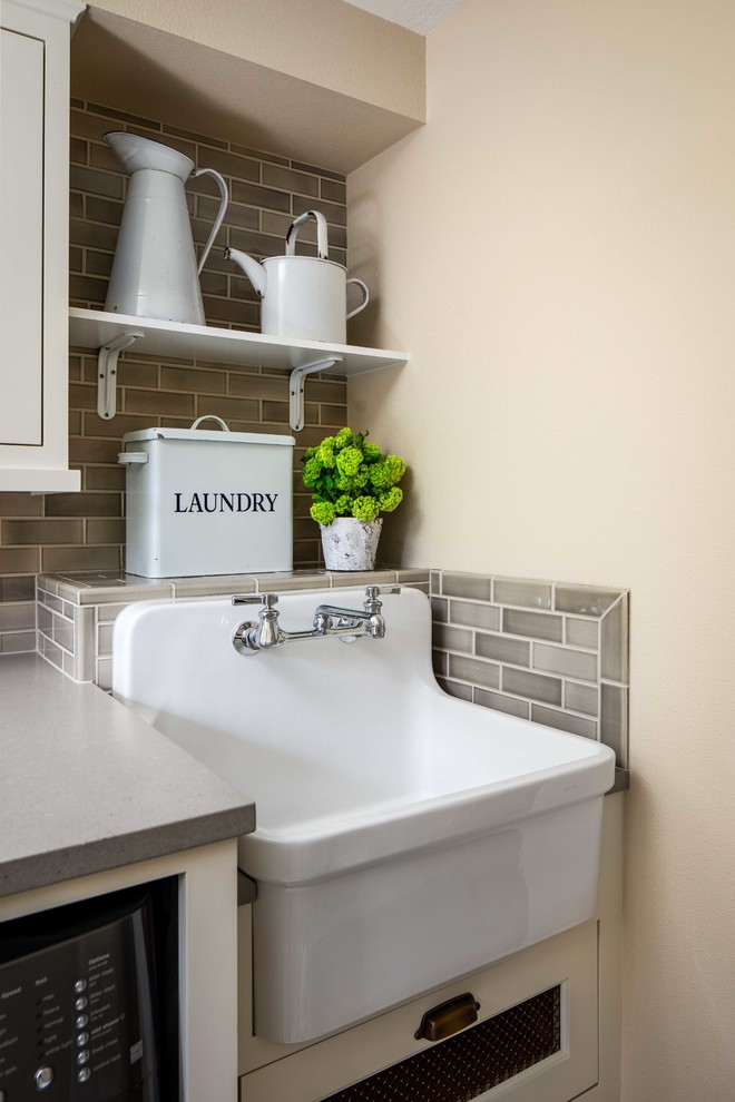 Mid-sized contemporary single-wall utility room in Portland with an undermount sink, beige walls, shaker cabinets, white cabinets and a side-by-side washer and dryer.