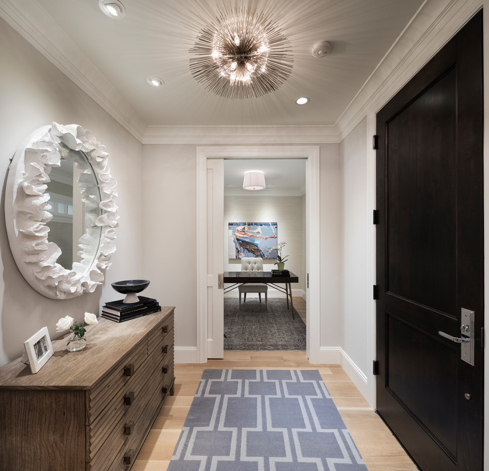 Example of a small transitional light wood floor and beige floor foyer design in Minneapolis with gray walls and a black front door
