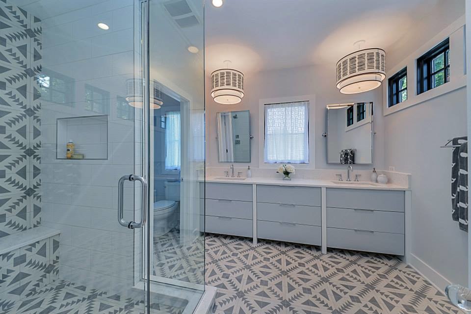 Example of a mid-sized transitional 3/4 gray tile, white tile and mosaic tile mosaic tile floor alcove shower design in Chicago with flat-panel cabinets, gray cabinets, a two-piece toilet, white walls, an undermount sink and solid surface countertops