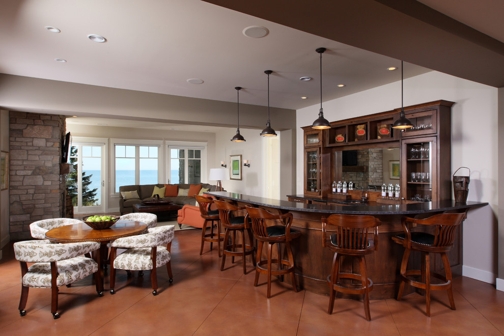 This is an example of a large traditional single-wall seated home bar in Grand Rapids with glass-front cabinets, dark wood cabinets, granite benchtops and porcelain floors.
