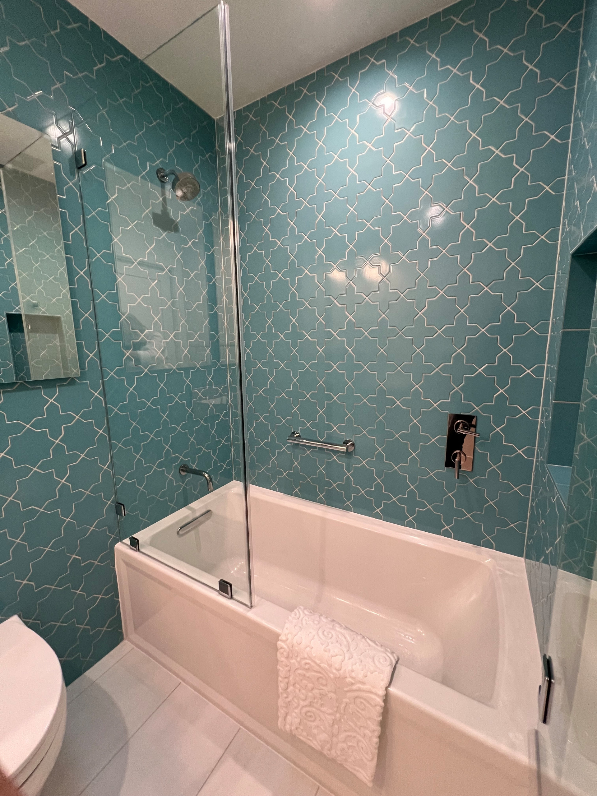 Floor to Ceiling Tile on Two Walls Create Fresh & Modern Atmosphere