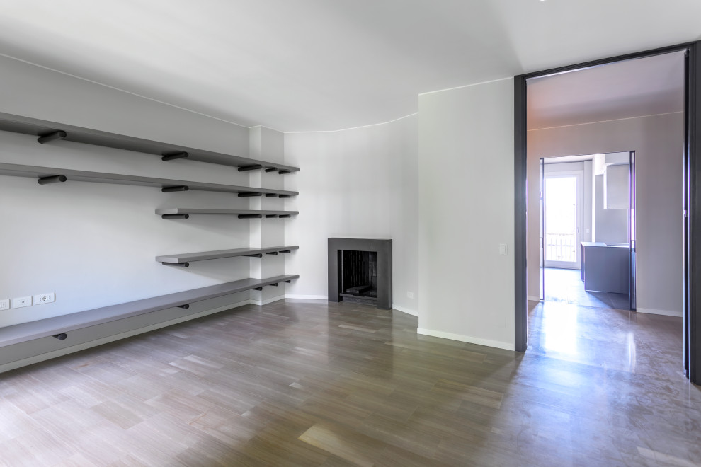 Example of a mid-sized trendy enclosed marble floor and beige floor living room library design in Milan with gray walls, a ribbon fireplace, a tile fireplace and a wall-mounted tv