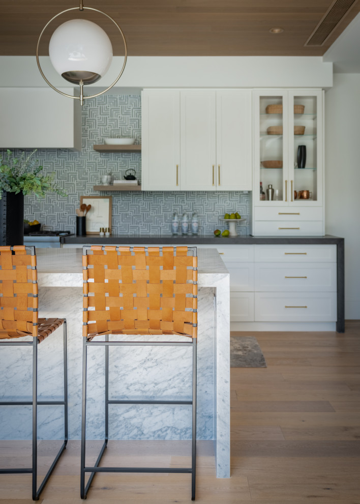 Kitchen - huge transitional light wood floor kitchen idea in Orange County with an undermount sink, quartzite countertops, mosaic tile backsplash and an island
