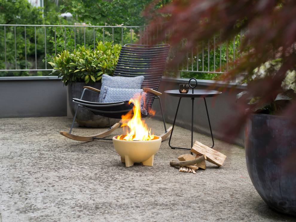 This is an example of a small arts and crafts backyard patio in Brisbane with a fire feature.