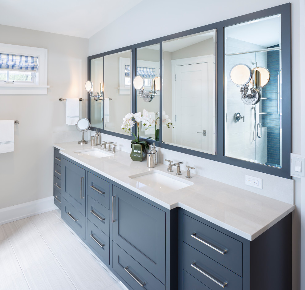 Photo of a large beach style master bathroom in Grand Rapids with recessed-panel cabinets, blue cabinets, grey walls, an undermount sink, engineered quartz benchtops, white floor, white benchtops, a double vanity and a built-in vanity.