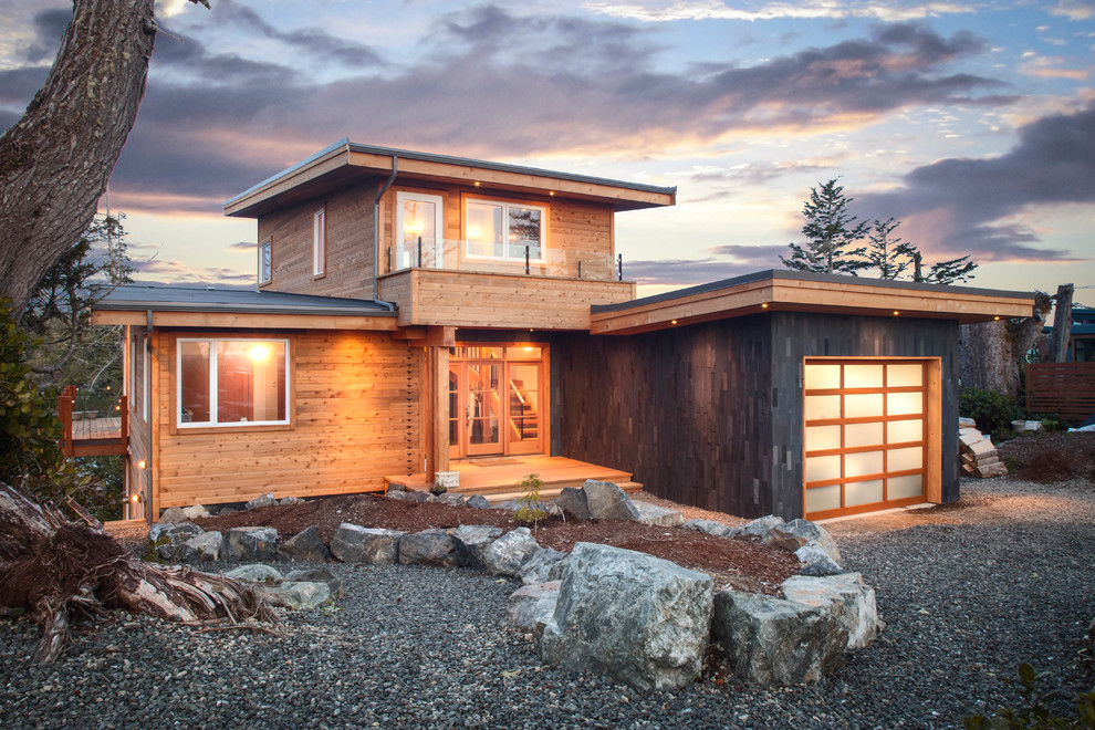 Photo of a contemporary two-storey exterior in Vancouver with wood siding.