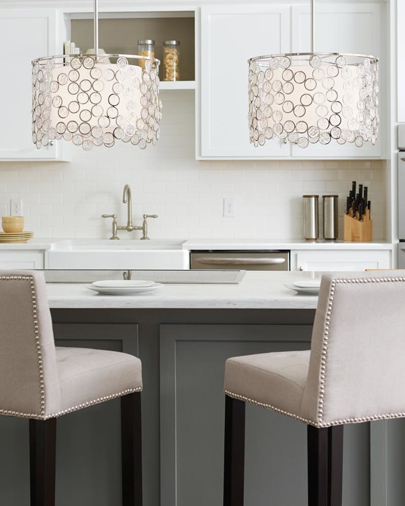 Example of a small transitional eat-in kitchen design with a farmhouse sink, recessed-panel cabinets, white cabinets, soapstone countertops, white backsplash, ceramic backsplash, stainless steel appliances and an island