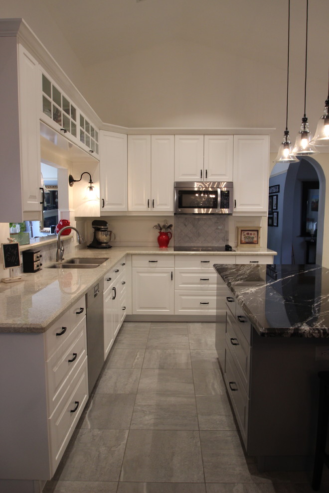 Example of a mid-sized transitional u-shaped ceramic tile and gray floor enclosed kitchen design in Phoenix with a double-bowl sink, raised-panel cabinets, white cabinets, marble countertops, gray backsplash, ceramic backsplash, stainless steel appliances and an island