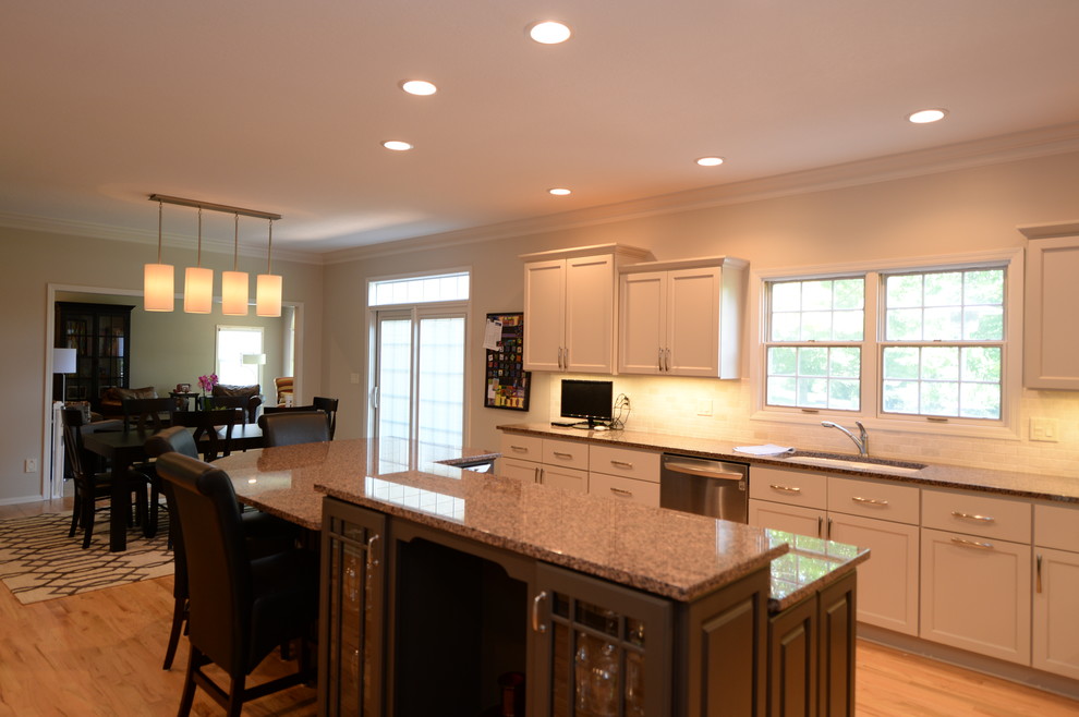 Large transitional l-shaped eat-in kitchen in Other with recessed-panel cabinets, white cabinets, stainless steel appliances and with island.
