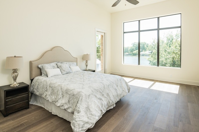 Design ideas for a mid-sized transitional master bedroom in Austin with white walls, medium hardwood floors and no fireplace.